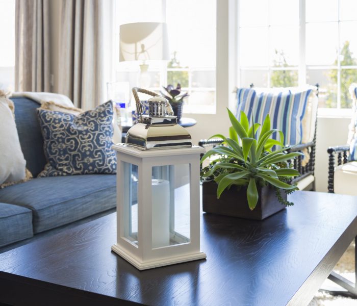Beautiful Blue Accented Living Area with Coffee Table, Couch and Chairs of Home. Beautiful Blue Accented Living Area with Coffee Table, Couch and Chairs of Home.